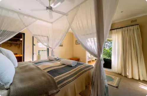 Bedroom 1 with king bed and canopy net