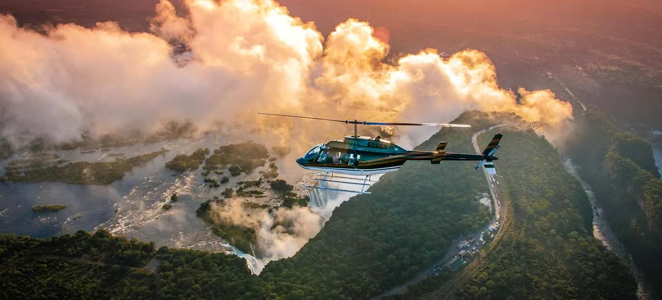 Helicopter on the Flight of Angels over Victoria Falls at sunset
